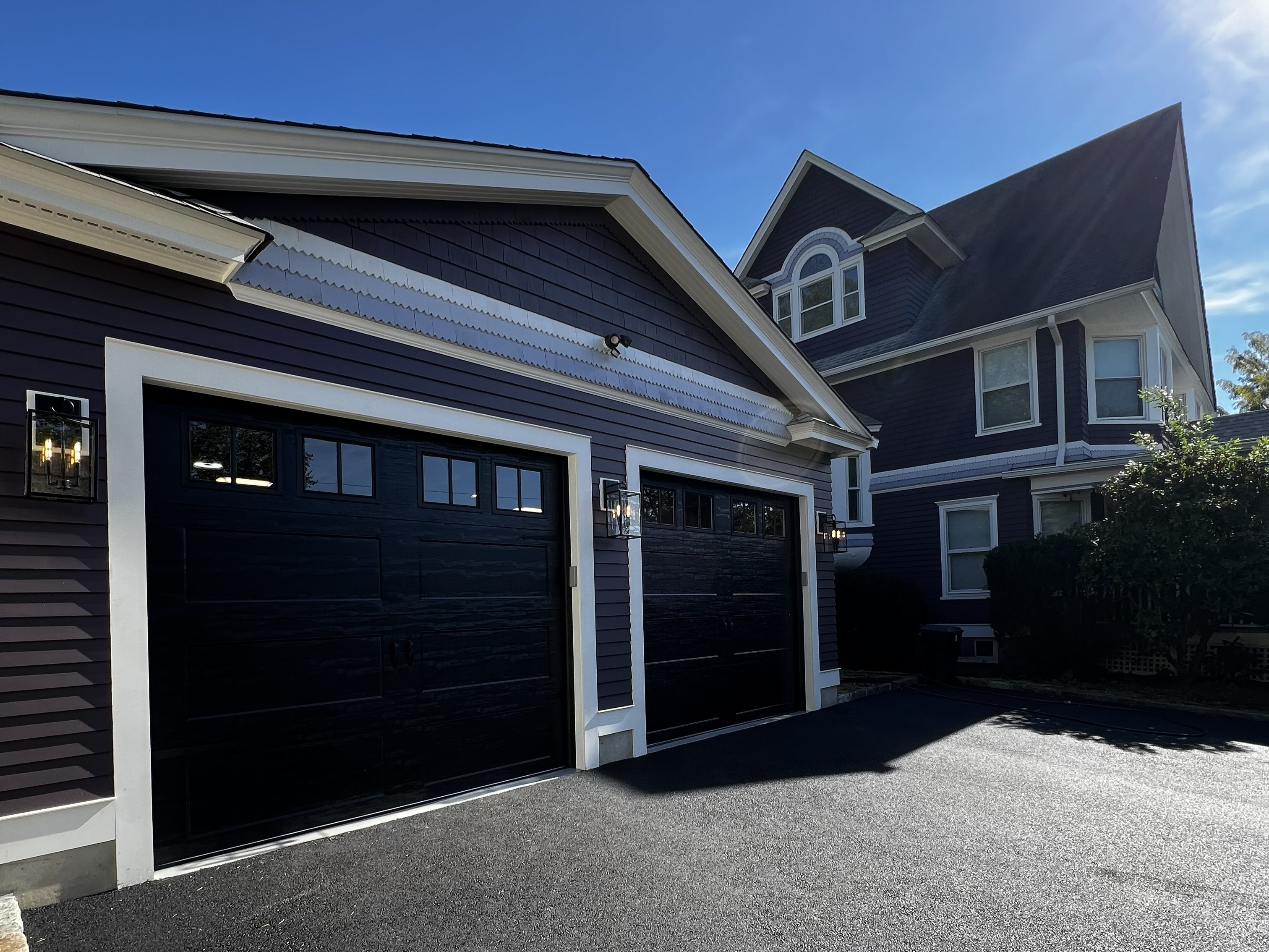 Professional black garage doors with fresh asphalt driveway - Eagle Overhead Door Union NJ