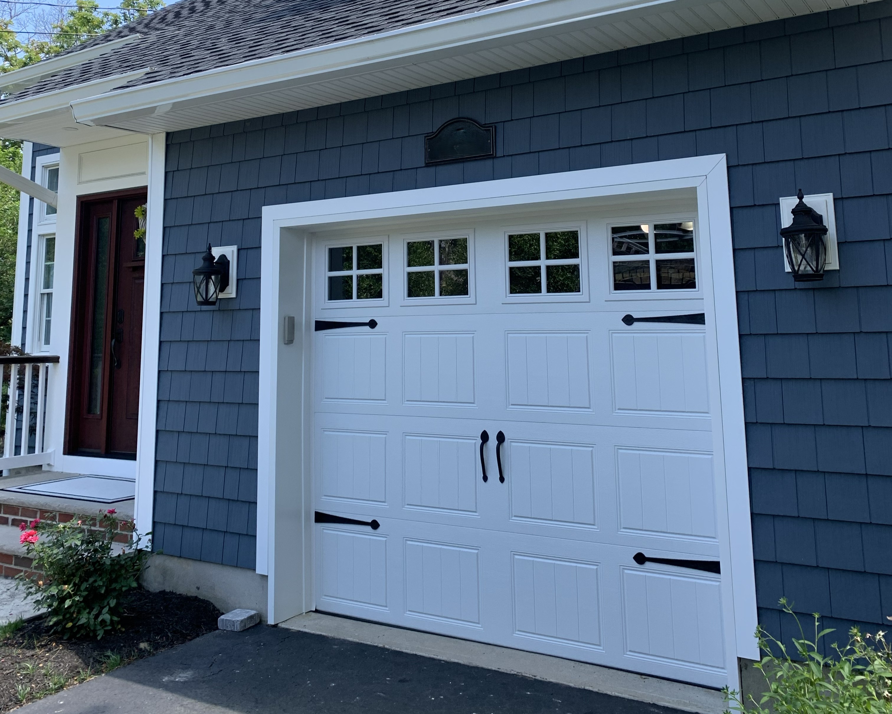 White garage door installation on blue house in New Jersey by Eagle Overhead Door