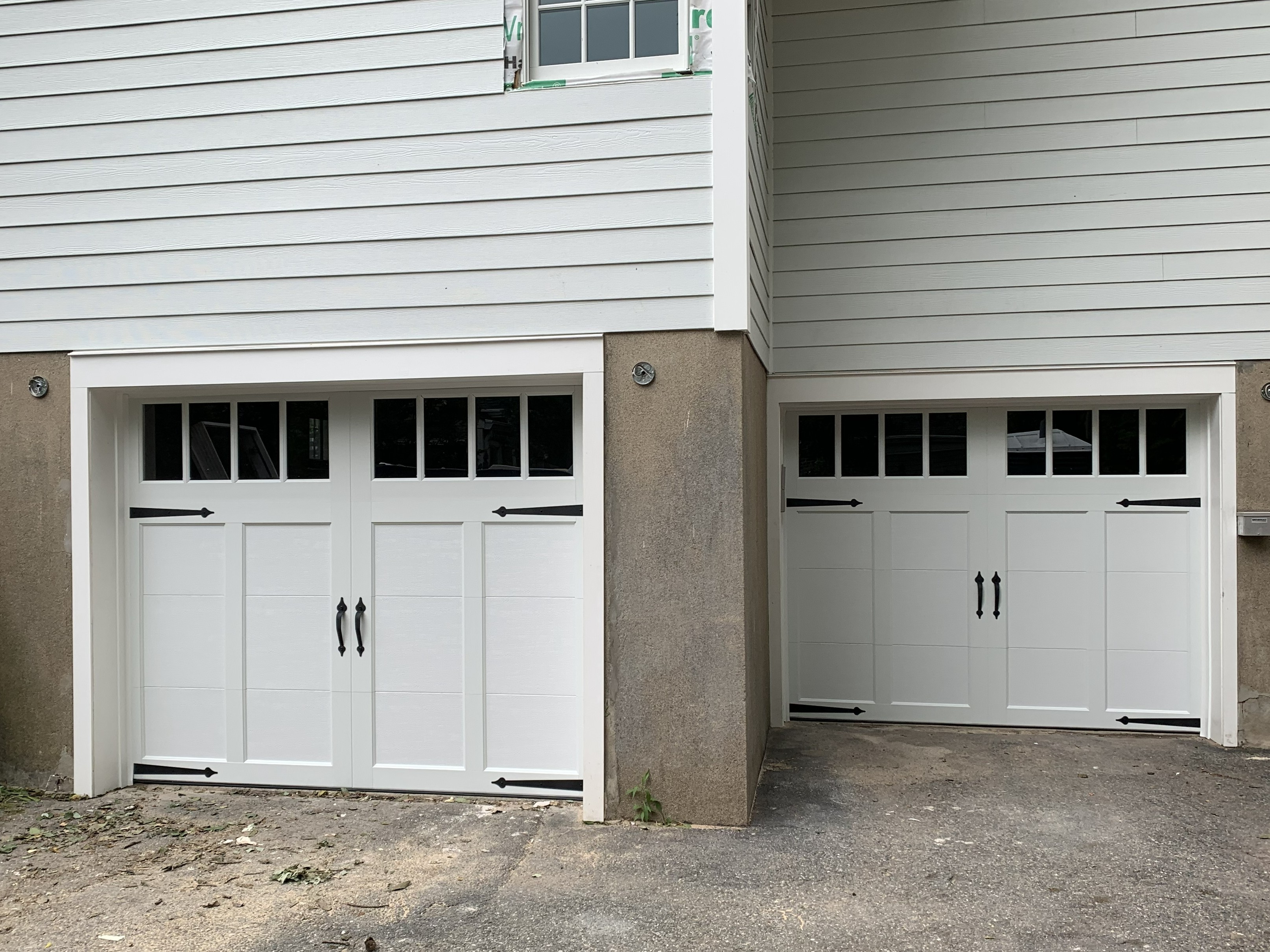 Two separate white garage doors installation in New Jersey