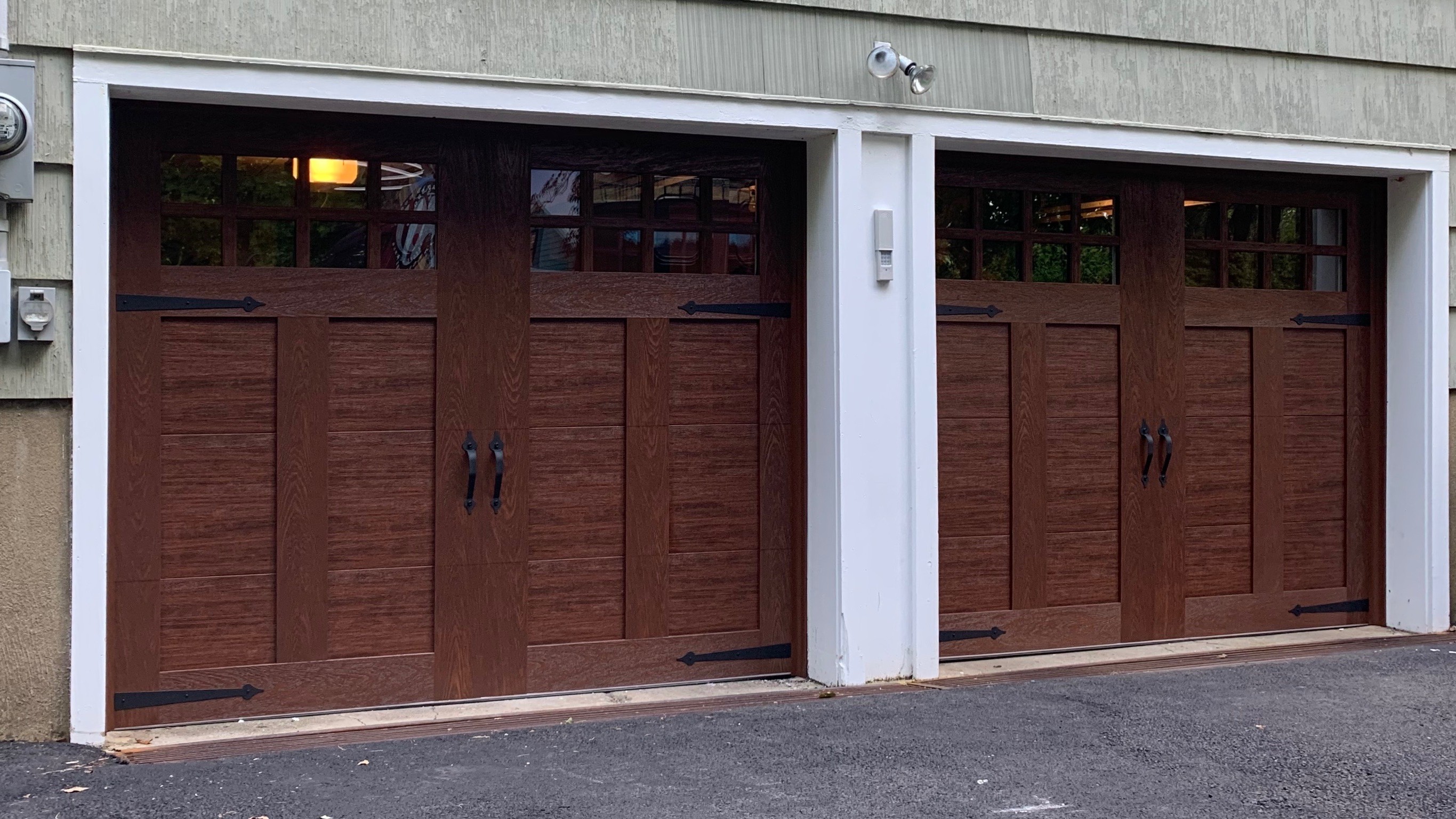 Twin brown wood-look garage doors installed in New Jersey by Eagle Overhead Door